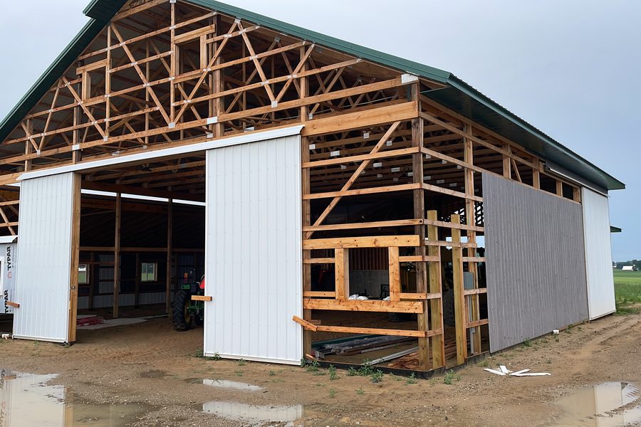 Now — Roof on. Doors hung. Not done yet.